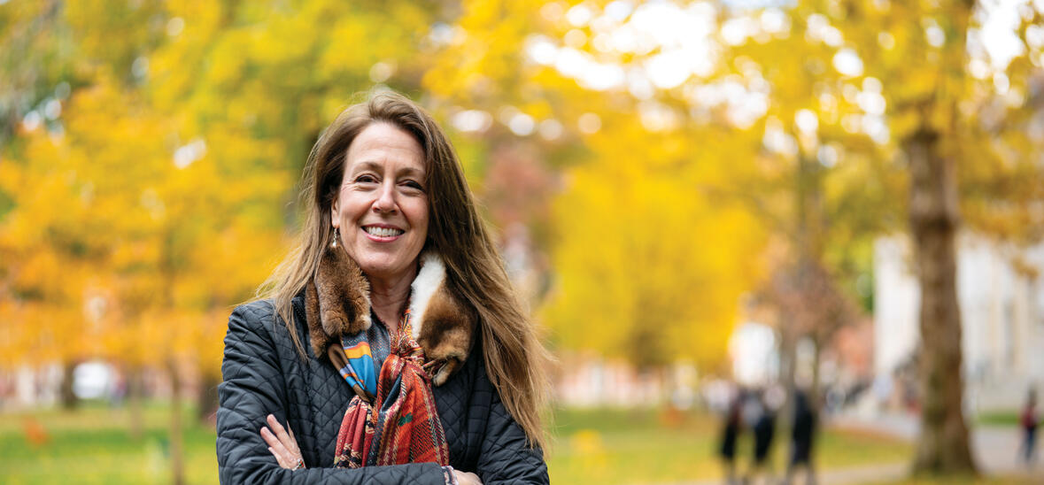 Jill Kastner in Harvard Yard; fall foliage in background