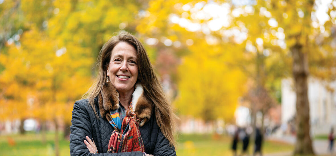 Jill Kastner in Harvard Yard; fall foliage in background