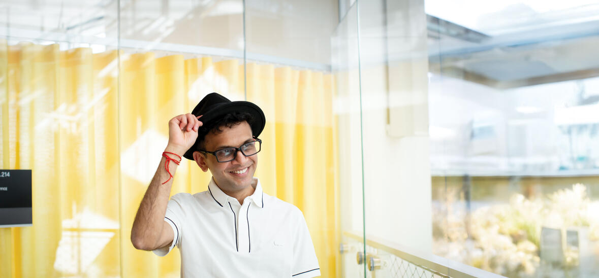 Rohan Murty tipping his black hat and smiling