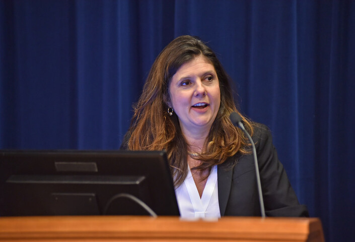 Betsey Stevenson speaking behind a podium