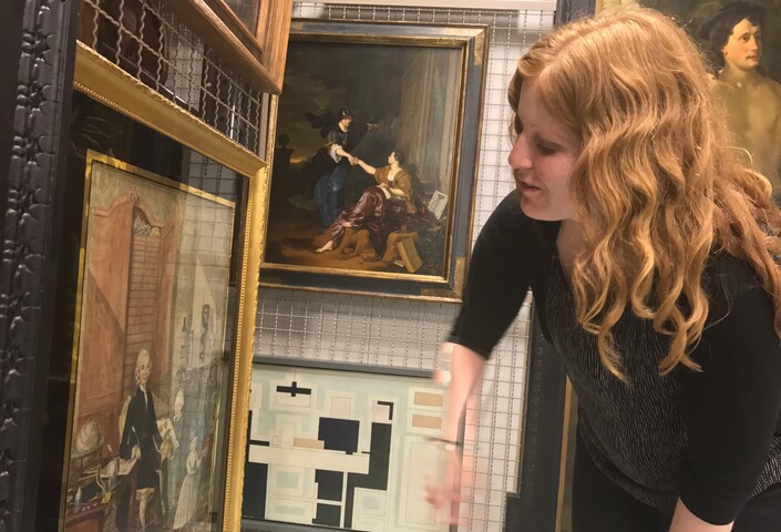 Robles examining the 1775 portrait of Dutch naturalist Laurens Gronovius and his sons at the Museum De Lakenhal’s offsite storage. Credit: William Robles