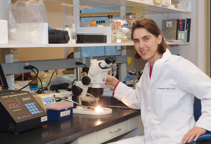 Dr. Stankovic sitting at desk in lab