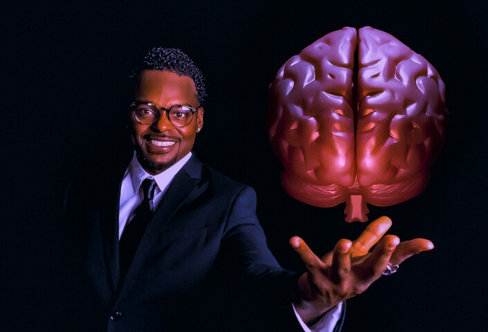 Brandon woods holding out hand to hold a brain