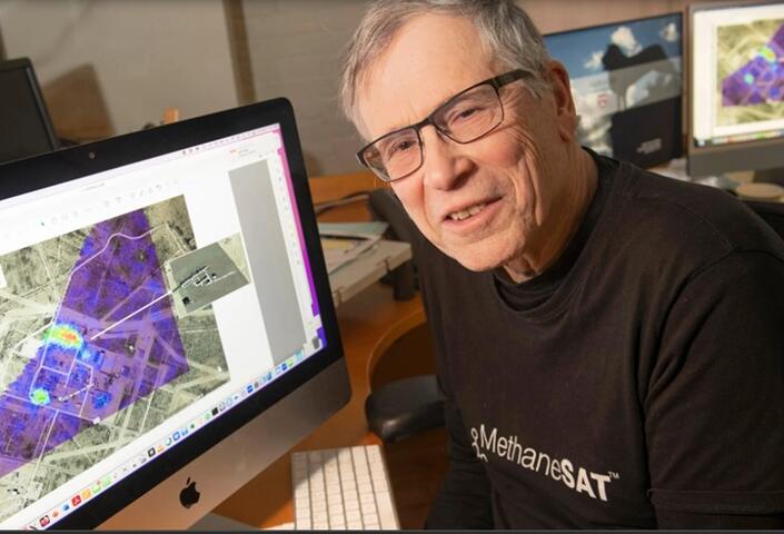 Professor Steven Wofsy seated smiling in front of a computer screeen