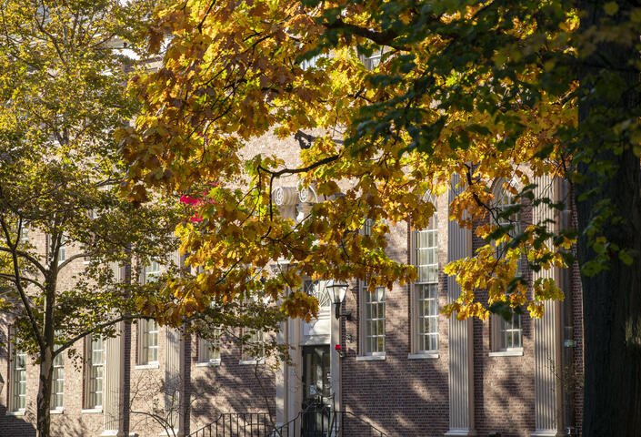 Lehman Hall, GSAS Student Center, through trees beginning to change colors