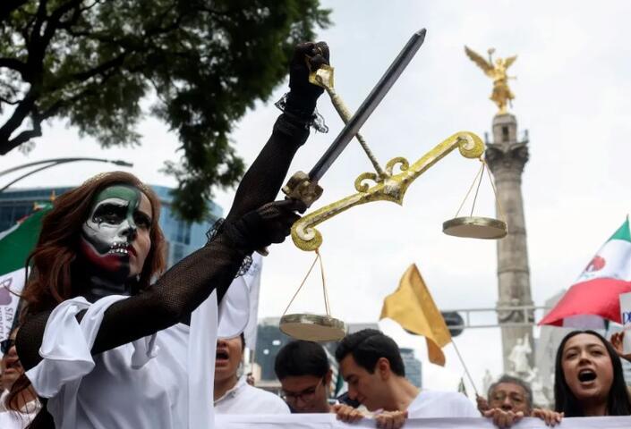 A young woman dressed as Lady Justice takes part in a protest against the judicial reforms proposed by the Mexican government in Mexico City on Sept. 8. 