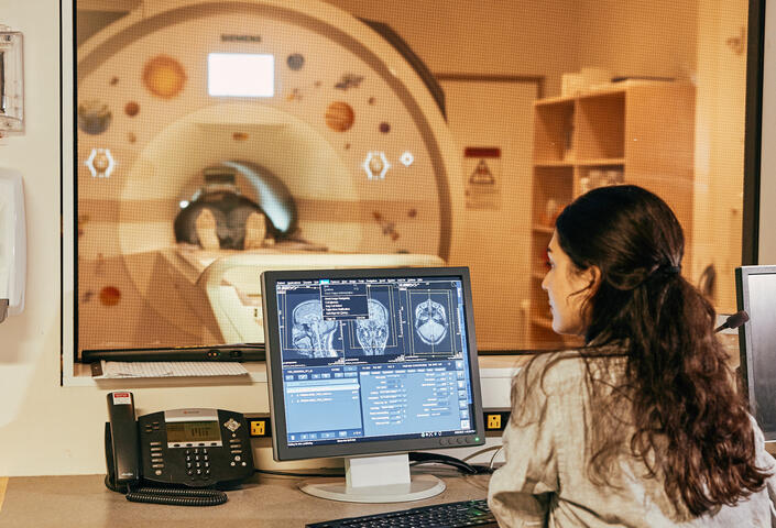 Saima Malik-Moraleda works on research in lab overlooking computer