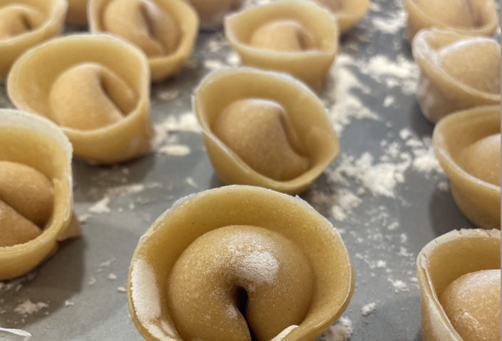 homemade pasta lined up on a pan