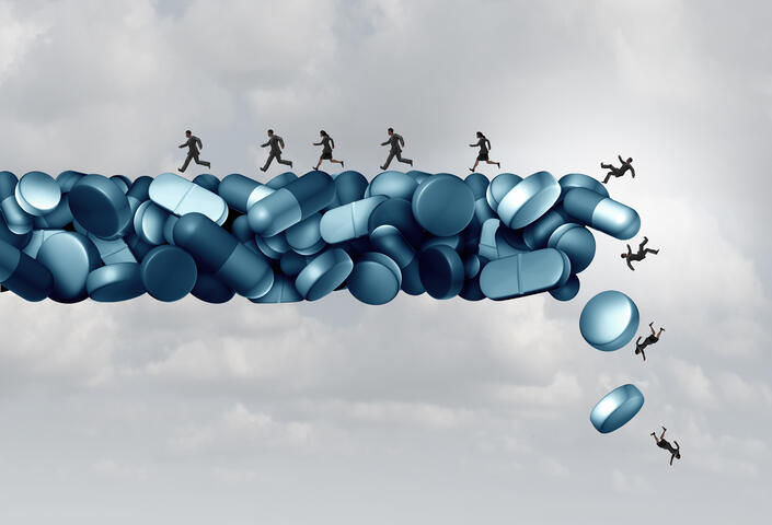 computerized artwork of people standing on piles of pills and falling off
