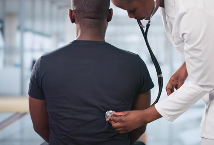 Photo of doctor with a stethoscope examining a patient