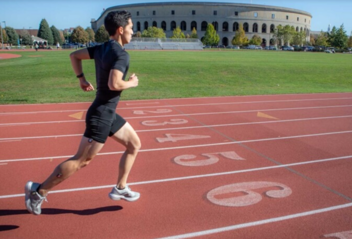 Study co-author Andrew Chin demonstrates the wearable sensors while running on the Harvard McCurdy Outdoor Track. 