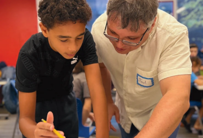 CMC instructor working with a young student