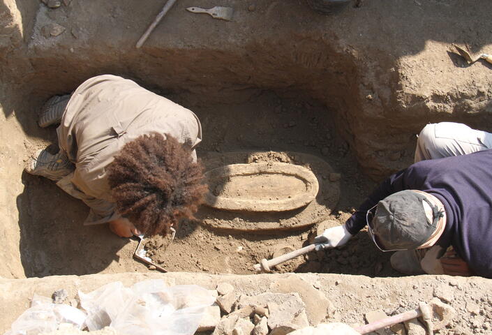 Melina excavating in a trench