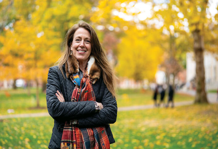 Jill Kastner in Harvard Yard; fall foliage in background