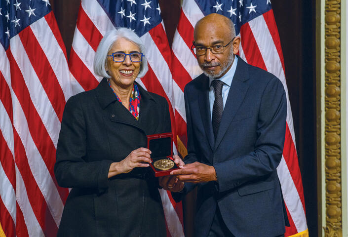 Emery receiving the medal