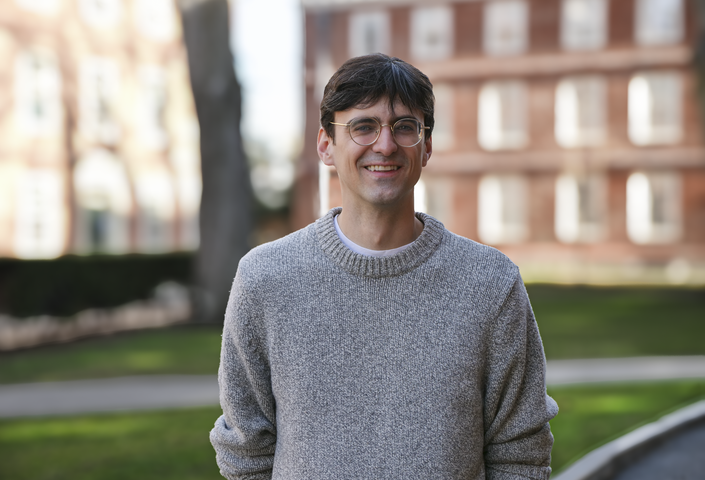 Andrew Bair wearing grey sweater in Harvard Yard
