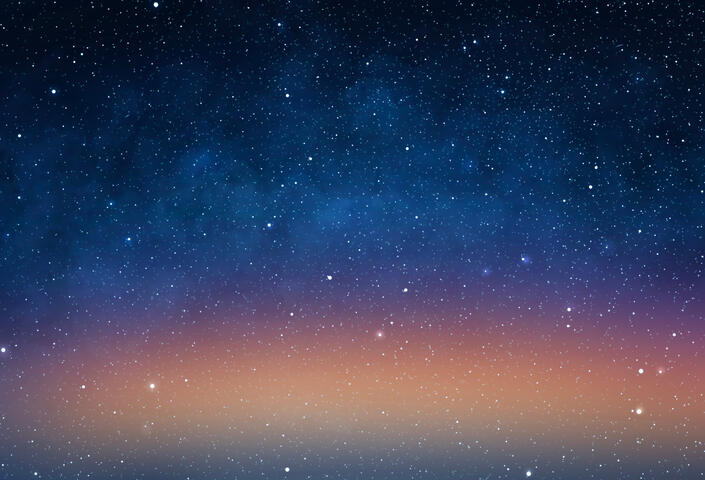 picture of a night sky filled with stars and orange tinted