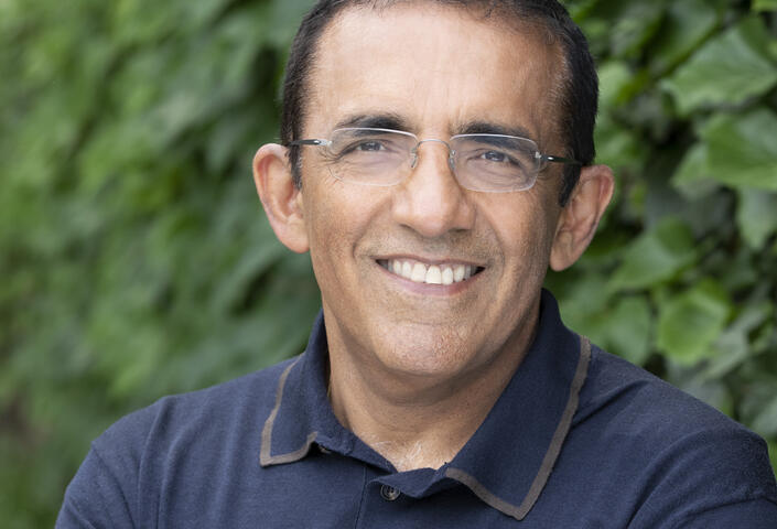 Ranjay Gulati in blue shirt with greenery background
