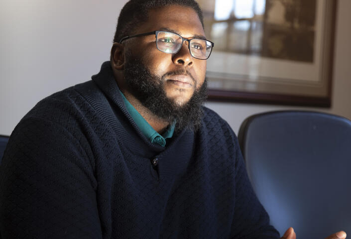 Anthony Abraham Jack leans forward in his chair