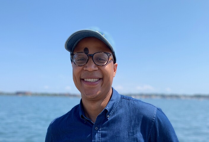 Lumumba Seegars in front of the ocean