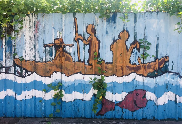 Street art depicting people at sea in a boat in Mahé, Seychelles
