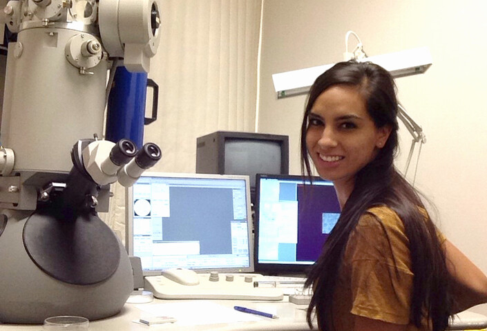 Kellie Jurado with Microsope in Lab