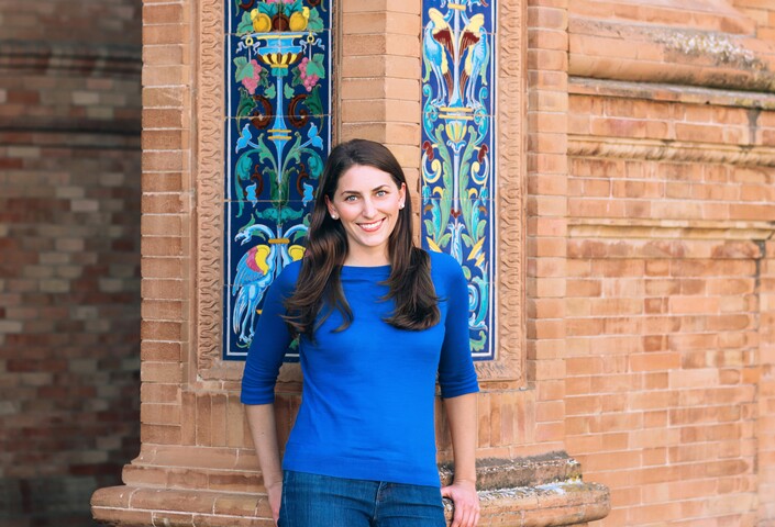 Malinda against brick column
