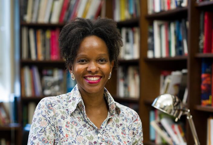 Imani Perry stands in front of bookshelves