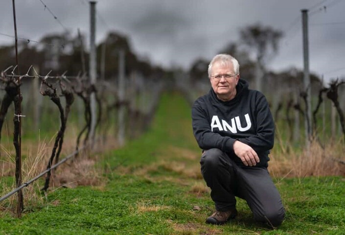 Brian Schmidt kneeling outdoors