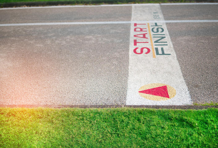 Start and finish line on street with grass