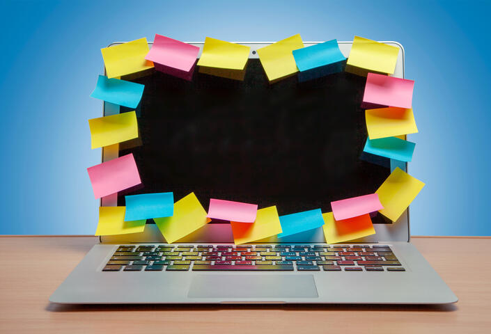 Post-its all over laptop computer