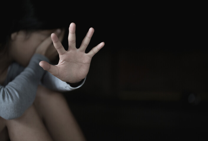 Hand of child in front of face