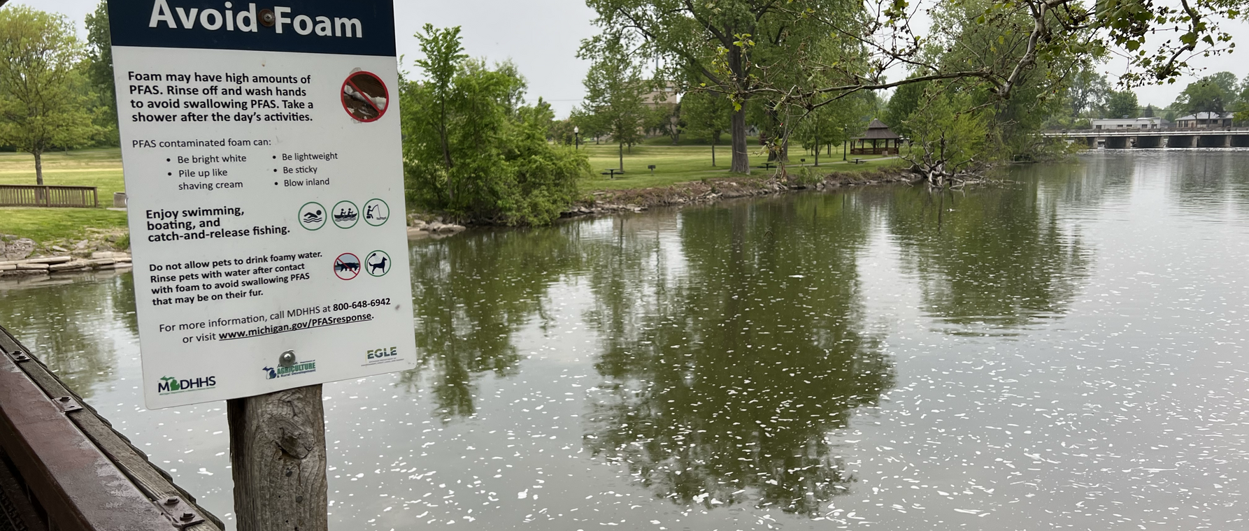 Sign to avoid foam containing PFAS on Huron River