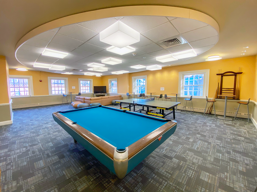 Large room with pool table, ping-pong table, sofa, and television