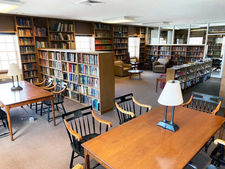 Library with bookshelves and tables 