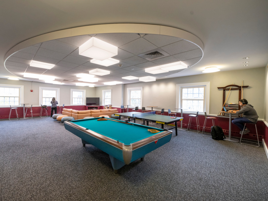 Game room with a pool table, pingpong table, large sectional couch, and TV