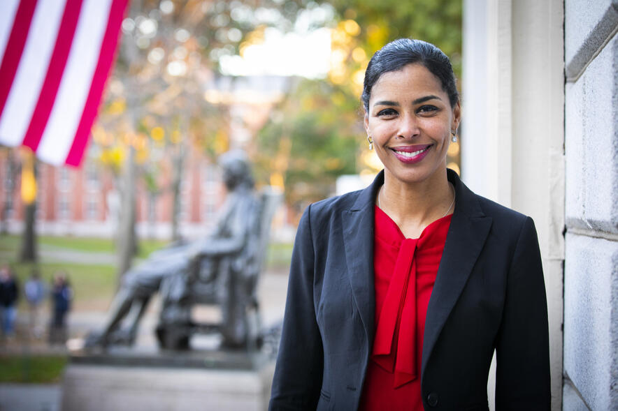 Portrait of Sara Bleich outside of University Hall with American Flag in background