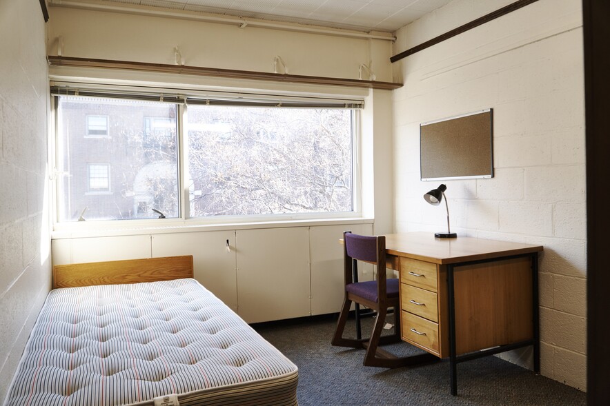 Unoccupied room in Richards hall with bed, desk, chair