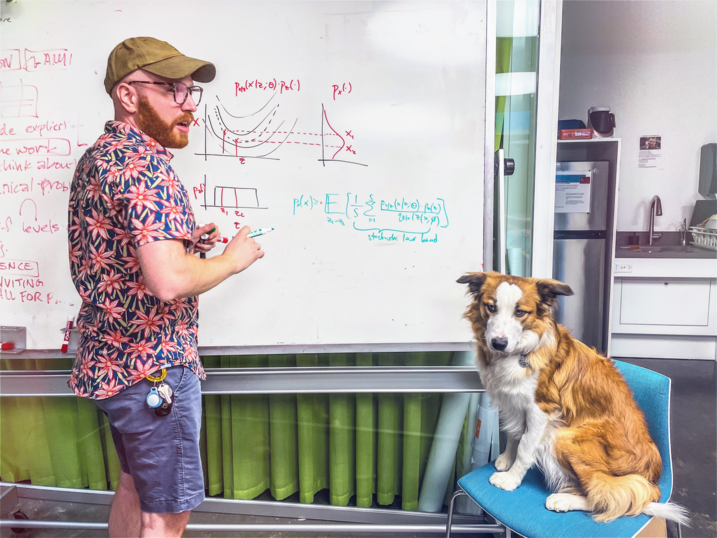 Yaniv Yacoby explaining his research to his dog, Paigu, and others (not pictured).