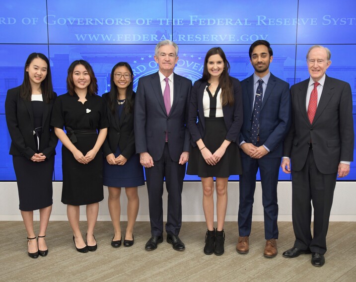 Laura Nicolae at the Federal Reserve with Jerome Powell (center). 