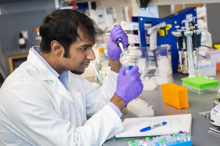 Ananthan Sadagopan in his lab holding materials