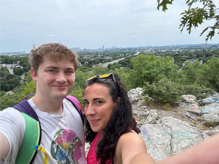 Gus Beane (left) with Elena Bellomi (right) on a hike in Middlesex Fells, with the Boston skyline in the background. 