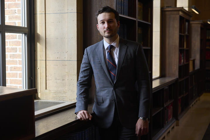 Andrew O'Donohue standing against window