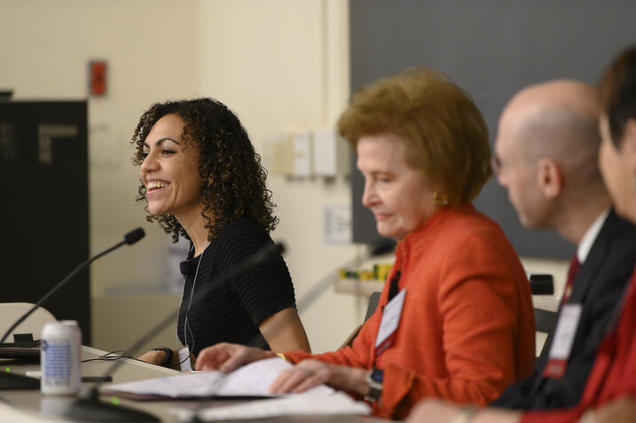 Alum smiling and speaking into microphone