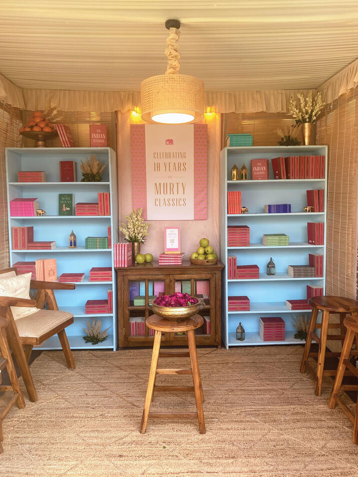 Murty Classical Library; books on colorful shelves and chairs in front