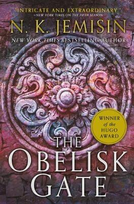 book cover for Obelisk Gate, showing an ornate stone carving, possibly on a gate
