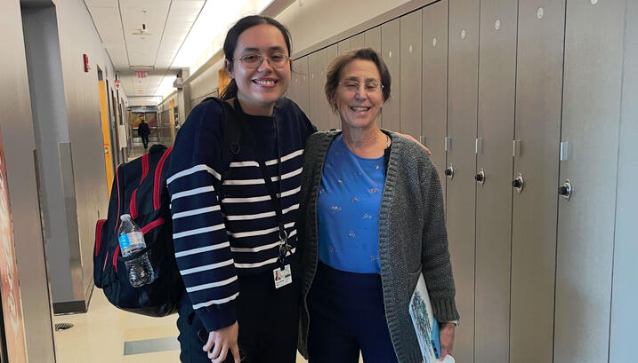 Apolonia and Professor Constance Cepko posing for a photo in front of lockers