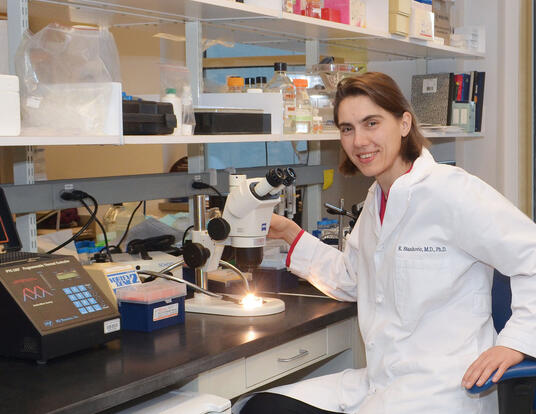 Dr. Stankovic sitting at desk in lab