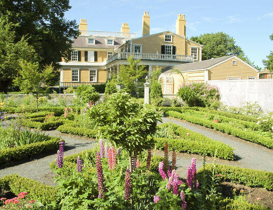 Longfellow house with greenery and gardens in front