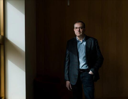 Photo of MIT economist David Autor standing in the shadows
